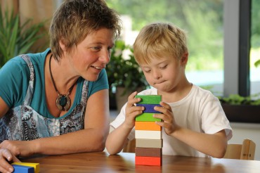 Teacher and pupil with building blocks